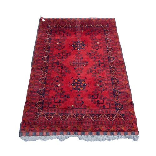 4 - GOOD QUALITY TURKOMAN BALOUCHI RUG, wine red with black design, having two floral medallions and del... 