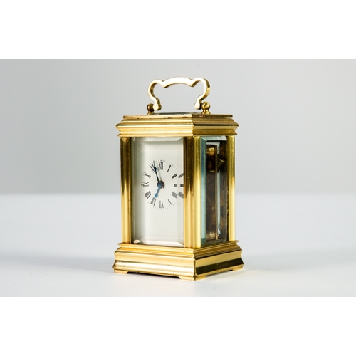 27 - TWENTIETH CENTURY BRASS CASED SMALL CARRIAGE CLOCK, of typical form with bevel edged oblong glass to... 