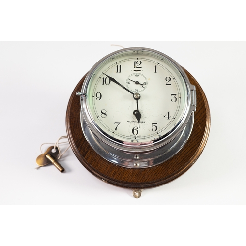 31 - KELVIN HUGHES CHROME PLATED PORTHOLE CLOCK, of typical form with subsidiary seconds dial and turned ... 