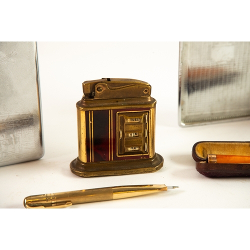 255 - SMOKING PARAPHERNALIA: faux tortoiseshell perpetual date calendar table lighter, gold mounted amber ... 