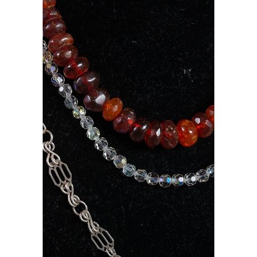 463 - SINGLE STRAND NECKLACE OF GRADUATED AND FACETED RED AMBER COLOURED BEADS; A SINGLE STRAND NECKLACE O... 