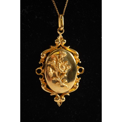 500 - GOLD PLATED OVAL LOCKET PENDANT applied with floral sprig, fancy rococo scroll surround, and the GOL... 