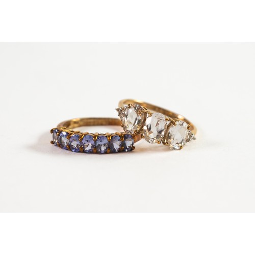 503 - 9ct GOLD RING set with a row of seven uniform tanzanite; and 9ct GOLD RING set with a row of three o... 