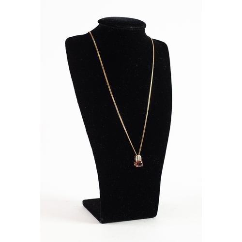 518 - 9ct GOLD GARNET PENDANT with small stone accents to the bale on a fine 9ct GOLD CURB CHAIN, 18