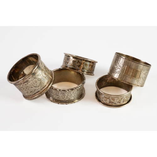 356 - FIVE EDWARD VII AND LATER SILVER NAPKIN RINGS, including an ivy leaf engraved pair, 2.30ozt, (5)