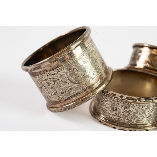 356 - FIVE EDWARD VII AND LATER SILVER NAPKIN RINGS, including an ivy leaf engraved pair, 2.30ozt, (5)