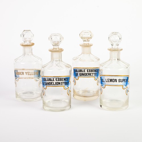 224 - SET OF 4 CUT GLASS JARS AND STOPPERS, each with a banner pattern 'Essence' label, 8