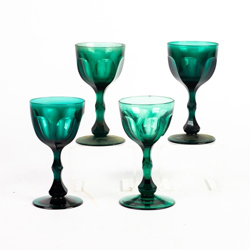 225 - SET OF 4 19TH CENTURY GREEN GLASS STEM WINES with thumb cut round bowls, hexagonally parallelled bal... 