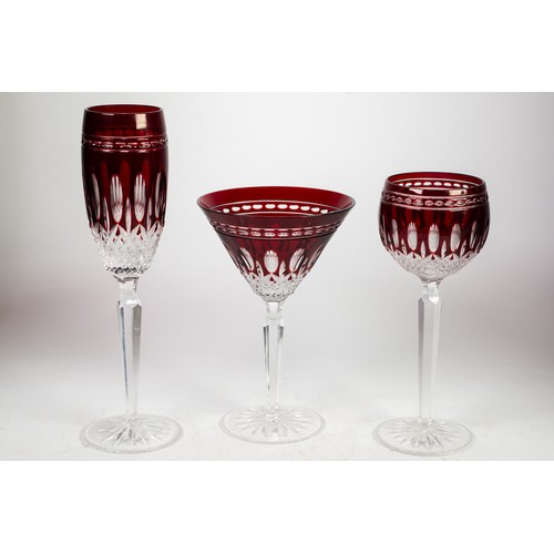 219 - THREE PAIRS OF MATCHING WATERFORD RUBY STAINED AND CUT TALL GLASSES, viz, pair of flutes with oval a... 