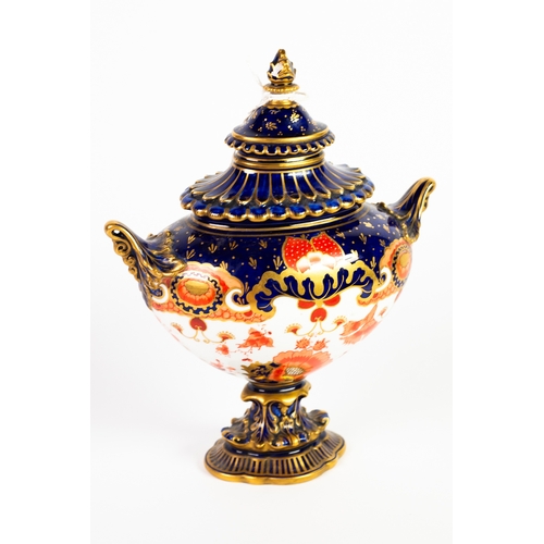 16 - LATE VICTORIAN ROYAL CROWN DERBY PORCELAIN TWO HANDLED BOAT-SHAPED VASE AND COVER, raised on a cushi... 