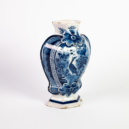 18 - ANTIQUE DUTCH DELFT BLUE AND WHITE VASE, ovular with hexagonal panels, with large embossed flower he... 