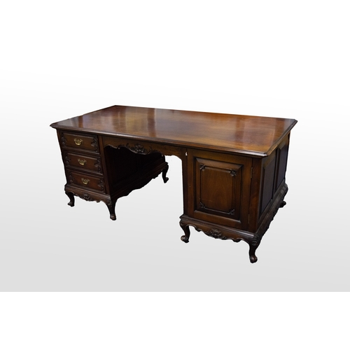 19 - MODERN GEORGE III STYLE MAHOGANY TWIN PEDESTAL DESK, the moulded top set above a central carved pane... 