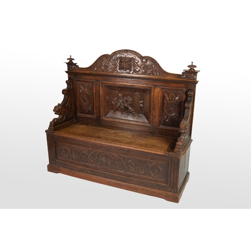 2 - NINETEENTH CENTURY HEAVILY CARVED OAK BOX SETTLE, the shaped back centred with a lion mask, set abov... 