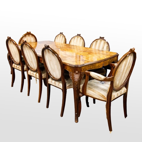 48 - MANNER OF EPSTEIN FIGURED WALNUT DINING TABLE AND SET OF EIGHT (6+2) DINING CHAIRS, The table with s... 