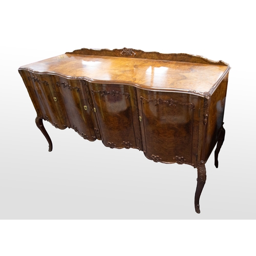 49 - MANNER OF EPSTEIN, SERPENTINE FRONTED QUEEN ANNE STYLE FIGURED WALNUT SIDEBOARD, the moulded top wit... 