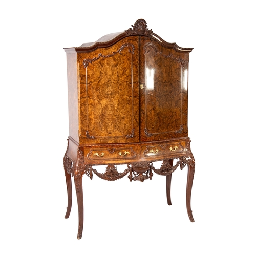 51 - MANNER OF EPSTEIN, SERPENTINE FRONTED QUEEN ANNE STYLE BURR WALNUT COCKTAIL CABINET, the shell cappe... 