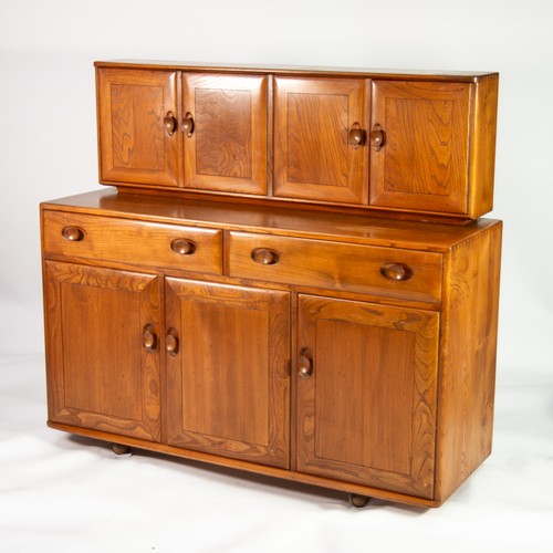 47 - ERCOL LIGHT ELM SIDE CABINET, the raised back with four cupboard doors, the left hand pair enclosing... 