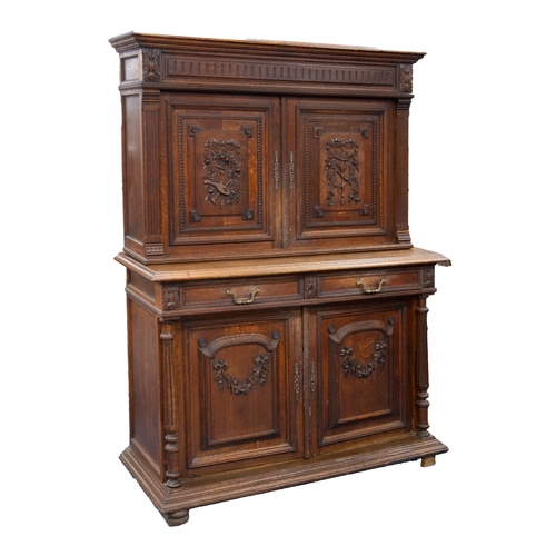 15 - EARLY TWENTIETH CENTURY FRENCH CARVED OAK PARLOUR CABINET, the dentil moulded cornice above a pair o... 