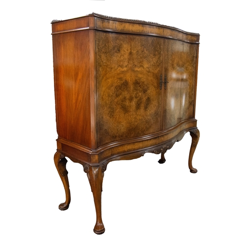 36 - EARLY TWENTIETH CENTURY FIGURED AND BURR WALNUT SERPENTINE FRONTED SIDE CABINET, the moulded cornice... 