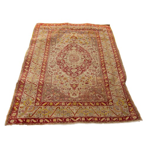 62 - SEMI-ANTIQUE KIRMAN RUG with concentric quatrefoil centre medallions with pendants on an ivory field... 