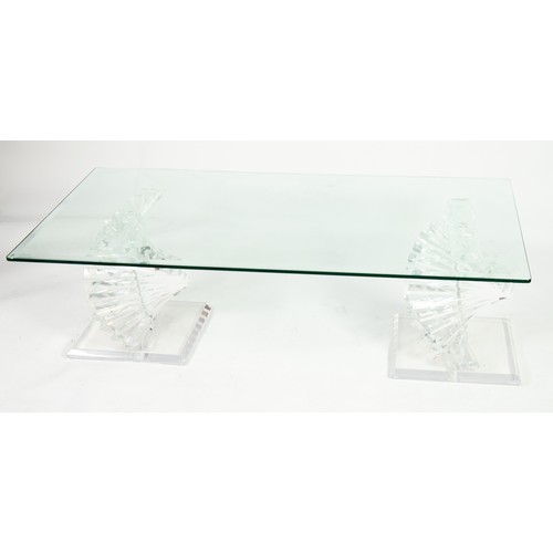 10 - A HEAVY BEVEL EDGE GLASS TOPPED COFFEE TABLE, RAISED ON TWO STYLISH SPIRAL PERSPEX BASES (132cm x 71... 