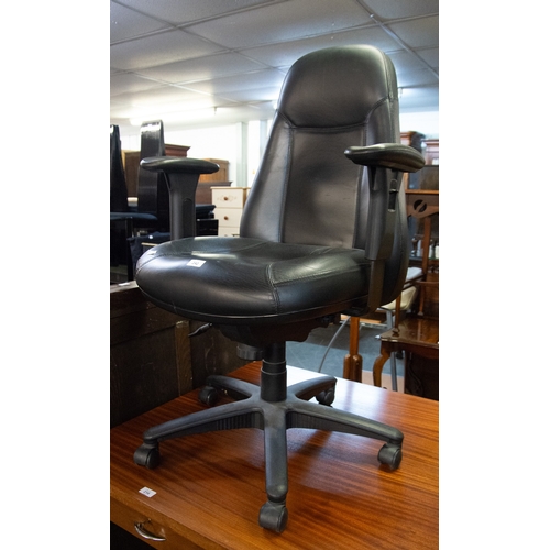 281 - EXECUTIVES BLACK LEATHER HIGH BACKED REVOLVING AND TILTING ARMCHAIR on black metal five spur base wi... 