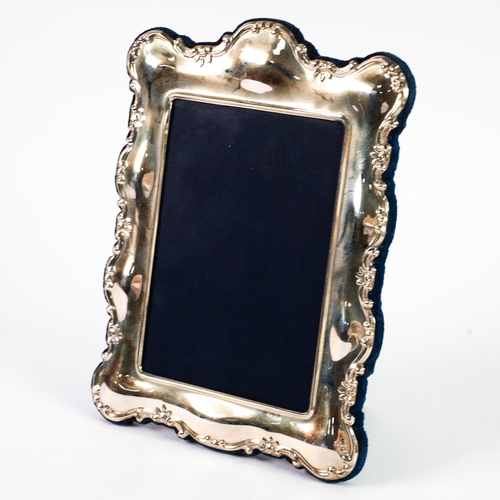 534 - PICTURE FRAME: A modern silver rococo picture frame with blue velour lining, marked for Sheffield 19... 