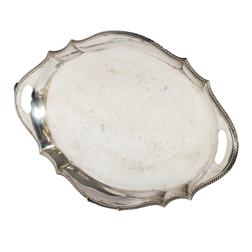 544 - SILVER TRAY: large George V boat shaped serpentine silver tray with gadrooned edge, marked Sheffield... 