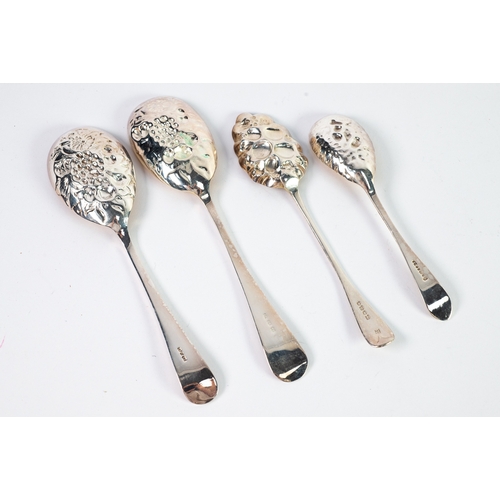 554 - BERRY SPOONS: a Victorian silver berry spoon with gilt repoussé bowl; together with three similar EP... 