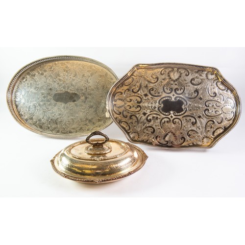 592 - THREE ELECTROPLATED GALLERIED TRAYS WITH FLORAL CHASED CENTRES, two of oval form, one with claw and ... 