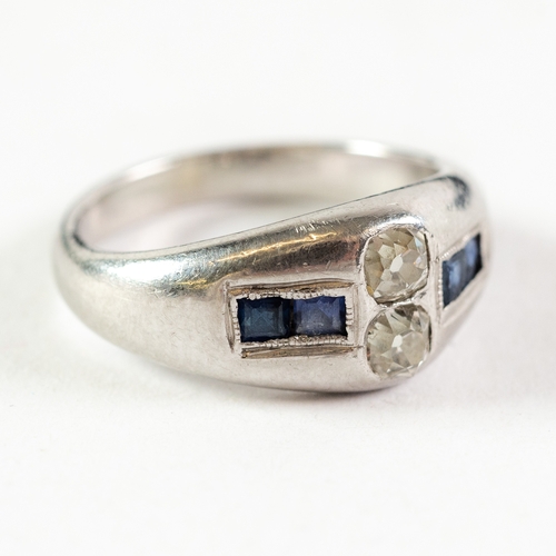 131 - PLATINUM RING, cross set with a pair of small diamonds flanked by pairs of small square cut sapphire... 