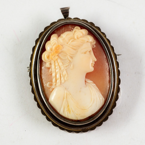 118 - OVAL SHELL CAMEO BROOCH/PENDANT, carved with a classical female head, in silver coloured metal frame... 