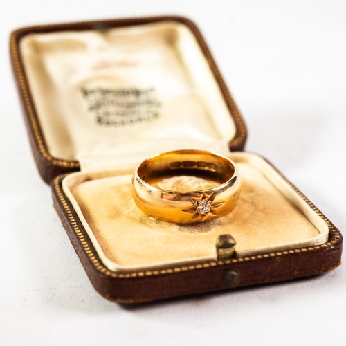 98 - GENT'S EDWARDIAN 18ct GOLD BROAD WEDDING RING, star set with a small diamond, approximately .07ct, 9... 