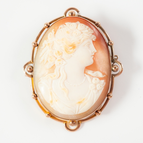 82 - LARGE OVAL CARVED SHELL CAMEO BROOCH, depicting a classical female head and GOLD COLOURED METAL FRAM... 