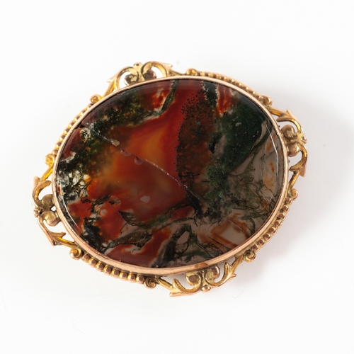 73 - OVAL MOSS AGATE BROOCH, (cracked) in 9ct GOLD FRAME with lower foliate scroll and beaded surround, 1... 