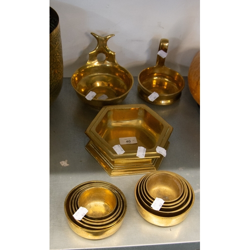 40 - HEAVY CAST BRASS CANDLE BOWLS IN THE FORM OF BLEEDING BOWLS; TWO SETS OF FIVE BRASS GRADUATED BOWLS,... 