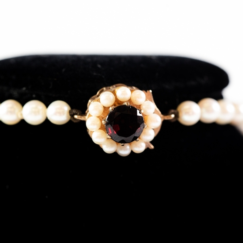 441 - SINGLE STRAND NECKLACE OF GRADUATED CULTURED PEARLS with 9ct gold circular clasp set with a centre g... 