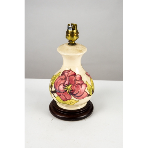 44 - TWO MODERN MOORCROFT MAGNOLIA PATTERN TUBE LINED POTTERY TABLE LAMPS, each painted in colours on a c... 