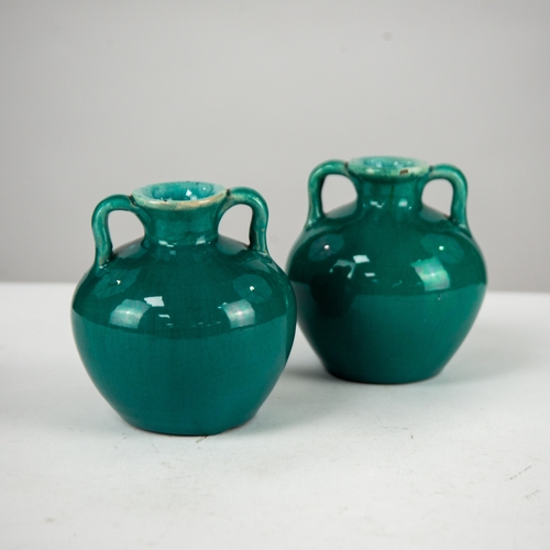 26 - PAIR OF DELLA ROBIA STUDIO POTTERY TWO HANDLED VASES, glazed in turquoise, 4” (10.2cm) high, incised... 