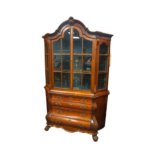 159 - A DUTCH MAHOGANY 19TH CENTURY BOMBE DISPLAY CABINET, the arched top centred by a carved mount above ... 