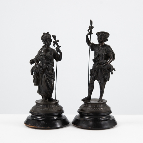 97 - PAIR OF EARLY TWENTIETH CENTURY SPELTER FEMALE FIGURES, each modelled standing, carrying a lamb and ... 