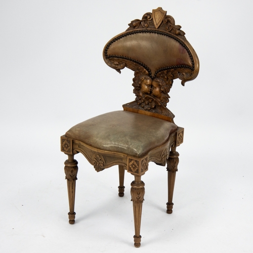 204 - LATE NINETEENTH/ EARLY TWENTIETH CENTURY ITALIAN CARVED WALNUT HALL CHAIR, the waisted back with clo... 