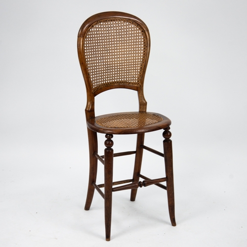 194 - VICTORIAN WALNUT CHILD’S CORRECTION CHAIR, WITH CANED SEAT AND BACK