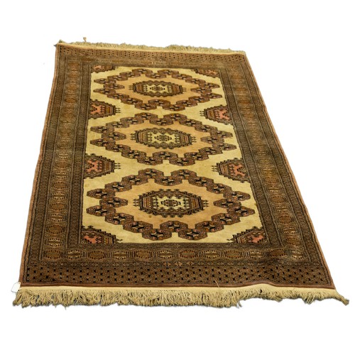 10 - SARIQ TURKOMAN RUG, with three large oval concentric medallions on a cream field, repeat serrated le... 