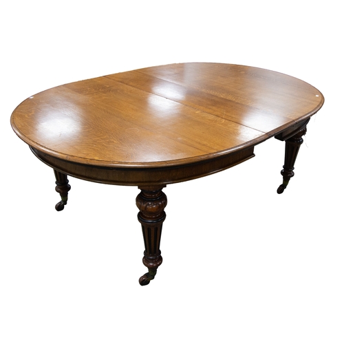 155 - LARGE LATE VICTORIAN LIGHT OAK EXTENDING DINING TABLE, oblong 'D' ended, raised on four 'C' scroll c... 