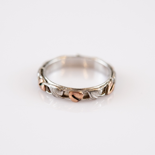 112 - CLOGAU WELSH SILVER AND GOLD VINE-EMBOSSED BAND RING with gold vine leaves, ring size 'N', in associ... 