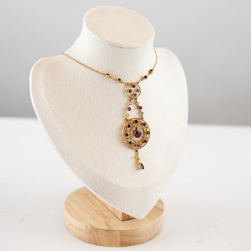 120 - AN EDWARDIAN 9ct GOLD FINE CHAIN NECKLACE with attached pendant, front set with amethysts and seed p... 