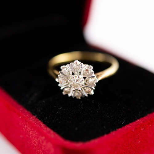 185 - 18ct GOLD AND DIAMOND CLUSTER RING, set with a raised centre diamond and petal shaped surround of ei... 