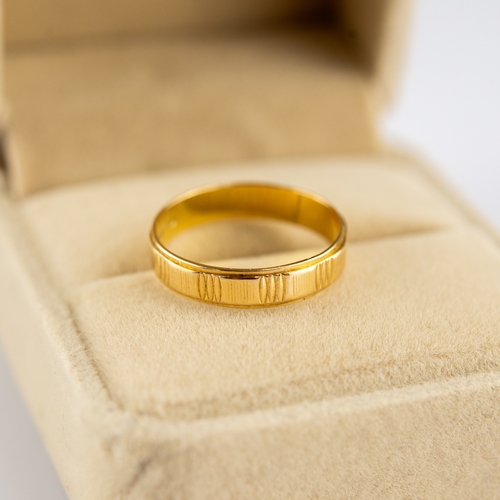 151 - 18ct GOLD BAND RING, engraved with lines between plain panels, 2.3gms, ring size L/M