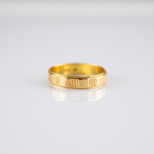 151 - 18ct GOLD BAND RING, engraved with lines between plain panels, 2.3gms, ring size L/M